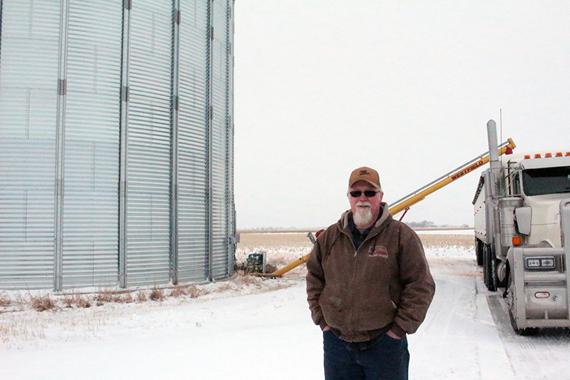 farmer fills a semi with corn