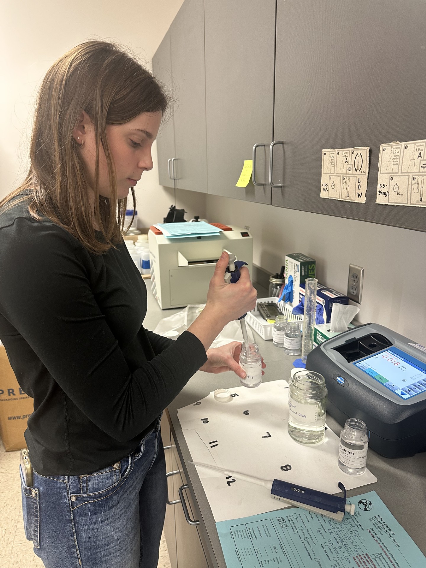 Emily Adelson tests a private well water sample at the lab.