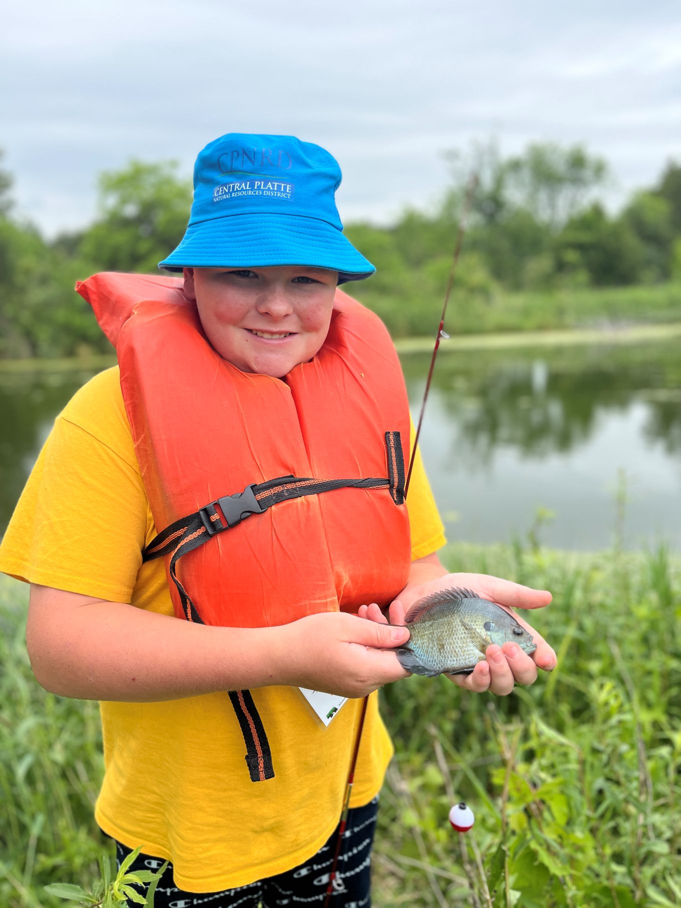 2025 ACE Camp participant holds a blue gill.