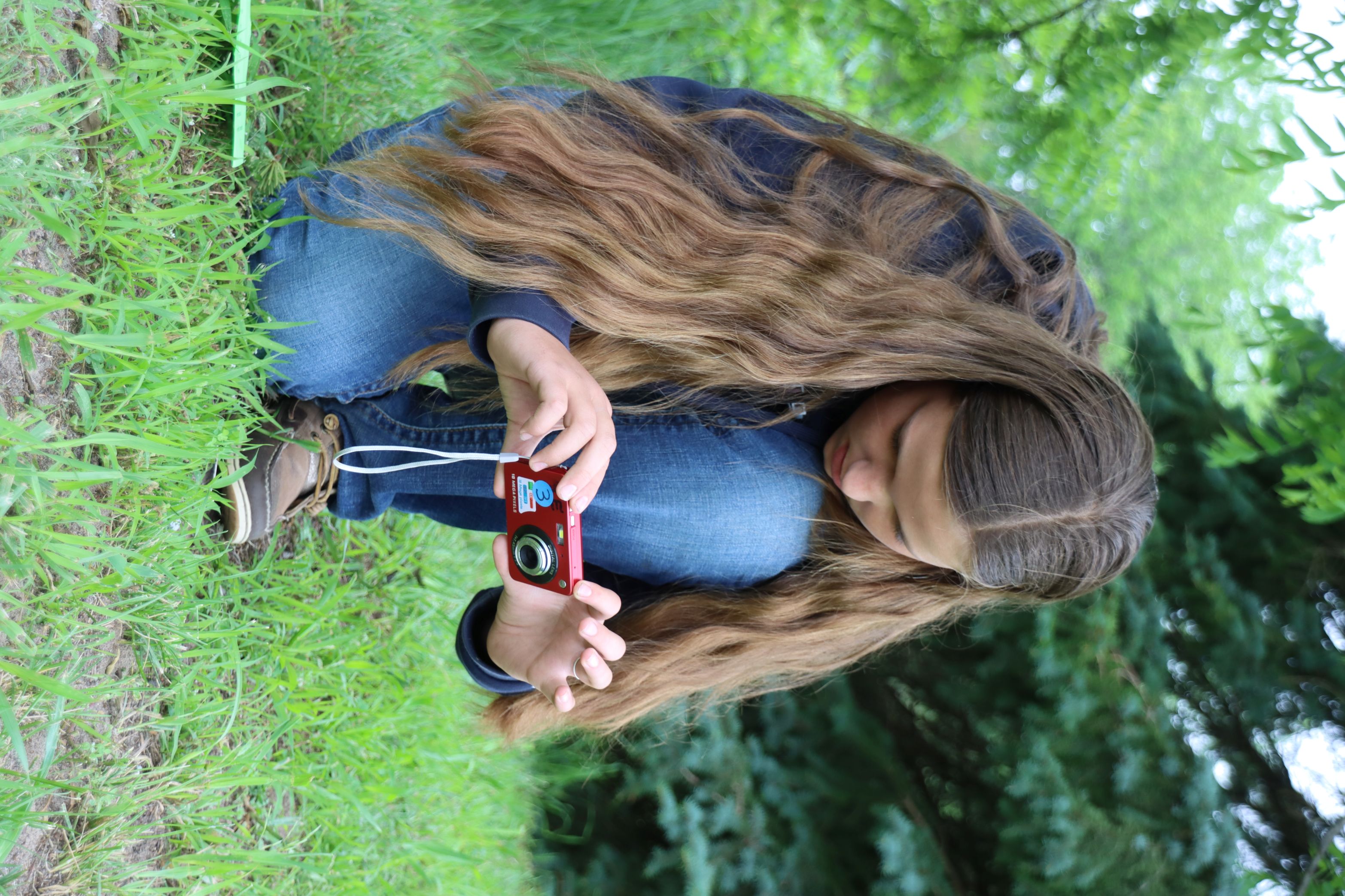 ACE Camp participant take a photo during an instructional session about photography.