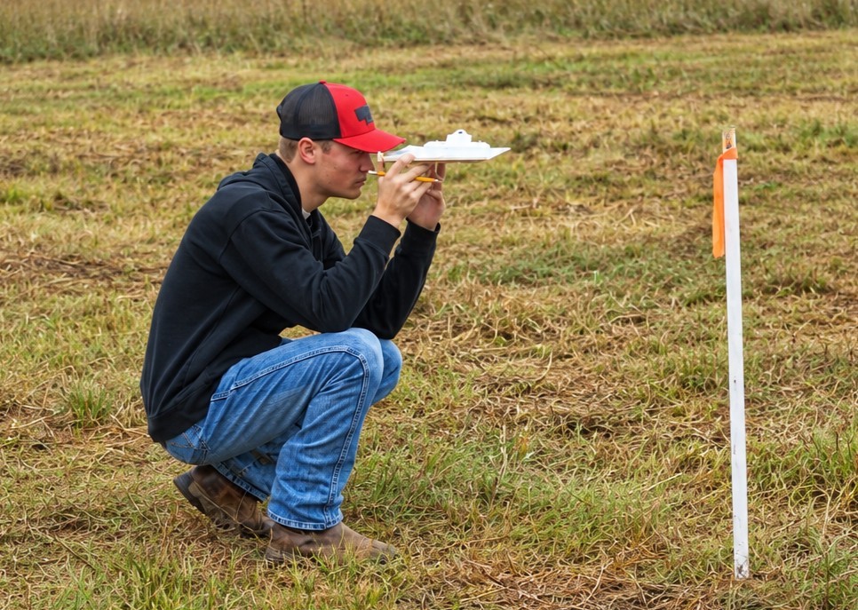 A student surveys the slope at the 2026 South Central Land Judging Contest