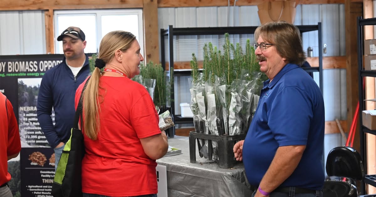 Terry Julesgard hands out free trees at Husker Harvest Days
