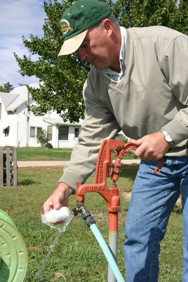 photo of a man collecting a water sample from a hydrant