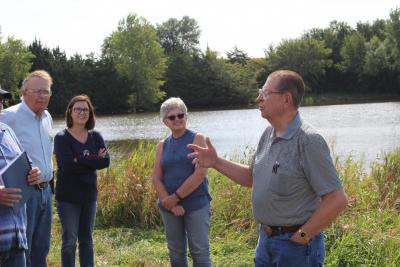 Dwaine Kubicek talks with members of the NRD board of directors at a proposed recreation site near Milligan.
