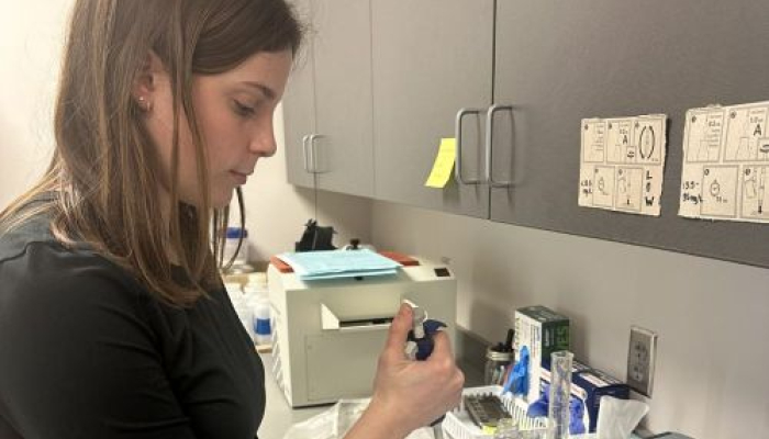 Emily Adelson tests a water sample for nitrates in the lab.