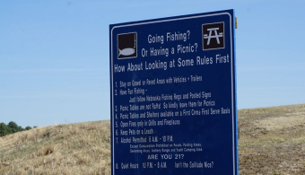 Blue sign with recreation area rules at Recharge Lake